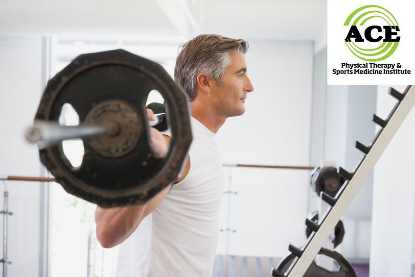 33931343 - fit man lifting heavy barbell at the gym